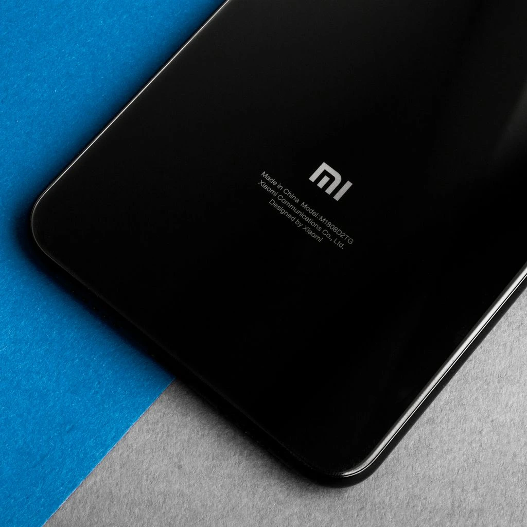 Xiaomi 14 Ultra in black, three-quarter angle on a charcoal background.