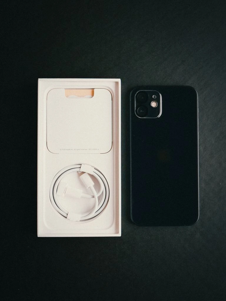 A flagship smartphone photographed on a dark editorial surface.